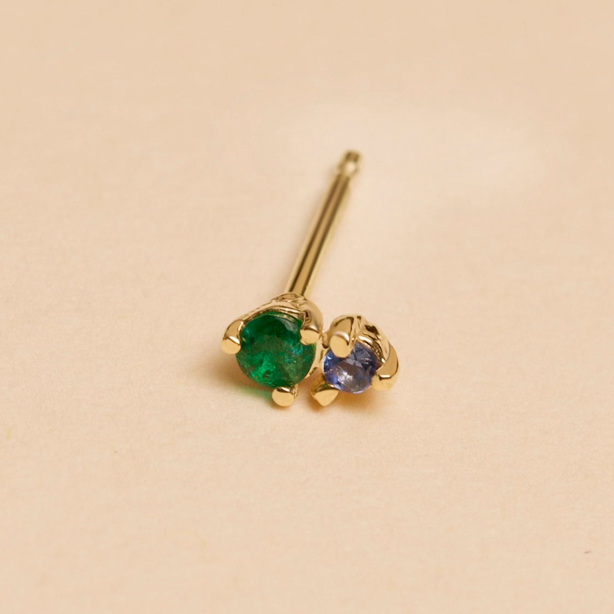 http://www.stoneandstrand.com/cdn/shop/products/EMERALD-AND-SAPPHIRE-BUDDY-STUD-EDITORIAL.jpg?v=1679597531