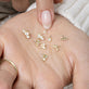 Still life image of (Flower Crown Diamond Ring) with Stone and Strand solid gold jewelry