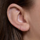 Image of 14K Yellow Gold Lab-Created Third Hole Huggies on Models Ear