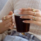 Model wearing Bold Merge Ring with solid gold Stone and Strand jewelry