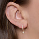 Image of 14K Yellow Gold Pave Bezel Diamond Drop Huggies on Models Ear