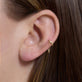 Image of 14K Yellow Gold Second Hole Mini Chain Reaction Huggie on Models Ear