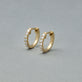 Stone and Strand 14K Yellow Gold Second Hole Diamond Pave Huggies Editorial Image