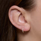 Image of 14K Yellow Gold Second Hole Diamond Pave Huggies on Models Ear