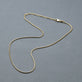 Stone and Strand 10K Yellow Gold Thin Snake Necklace Editorial Image