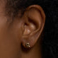 Image of 10K Yellow Gold Tiny Bubble Tea Initial With Diamond Earring on Models Ear