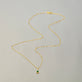 Stone and Strand 14K Yellow Gold Tiny Green Goddess Diamond and Emerald Necklace Editorial Image