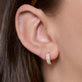 Image of 14K Yellow Gold Twinning Pave Diamond Huggies on Models Ear