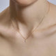 Image of 14K Yellow Gold Tiny Diamond Cross Necklace on Models Neck