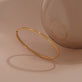 Still life image of Golden Classic Bangle with Stone and Strand solid gold jewelry