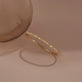 Still life image of Tiny Together Forever Diamond Bangle with Stone and Strand solid gold jewelry